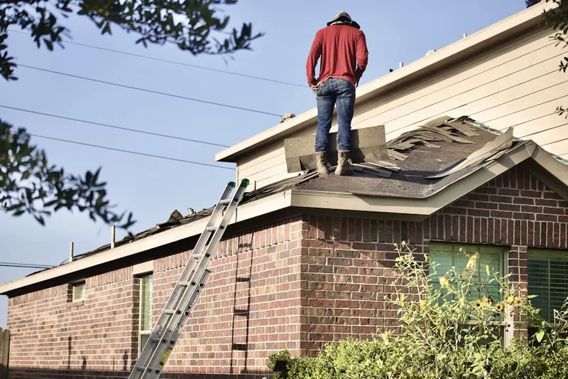 Professional roofer working on a residential roof in Pace